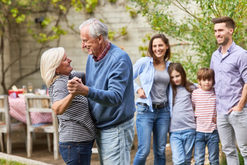 Grandparents are dancing in front of family at celebration in th
