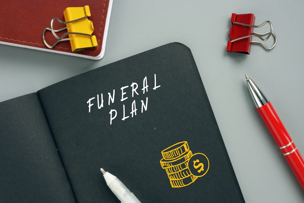 FUNERAL PLAN sign on the piece of paper. A Funeral Plan is an